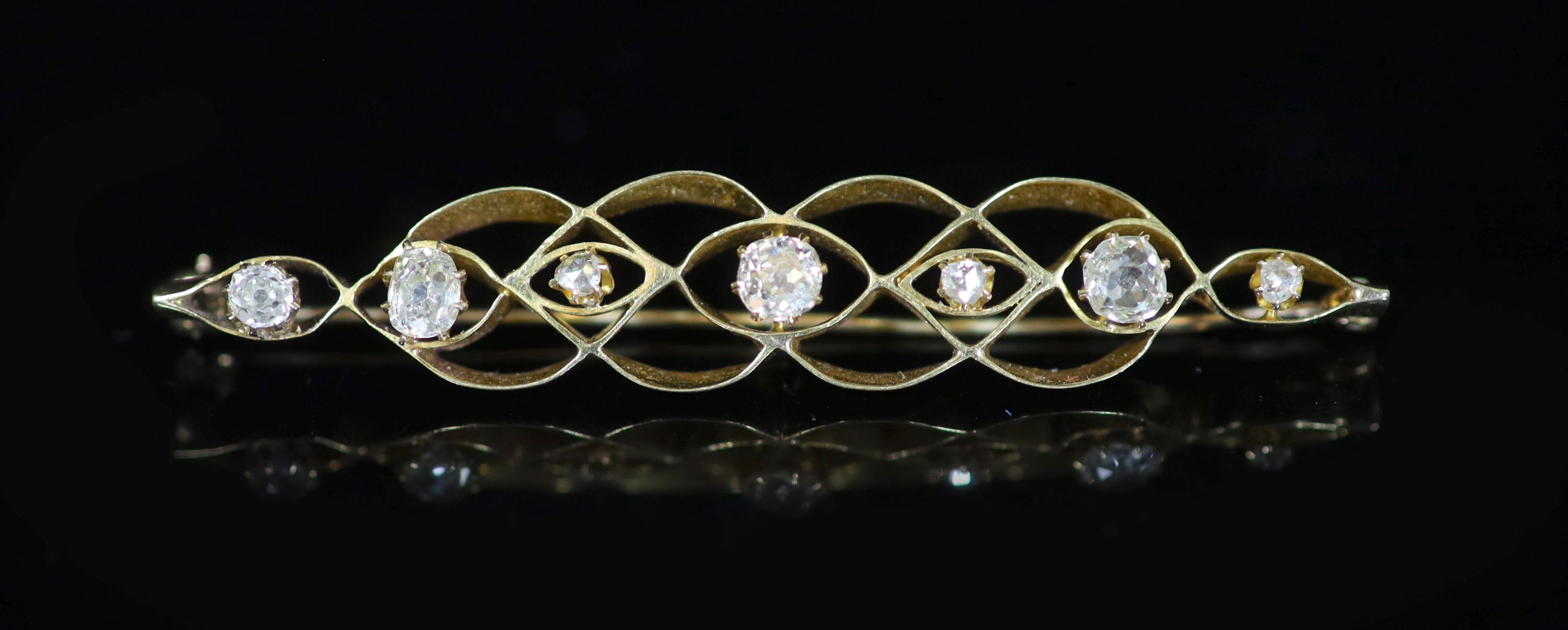 A gold and seven stone graduated rose and old mine cut diamond set bar brooch